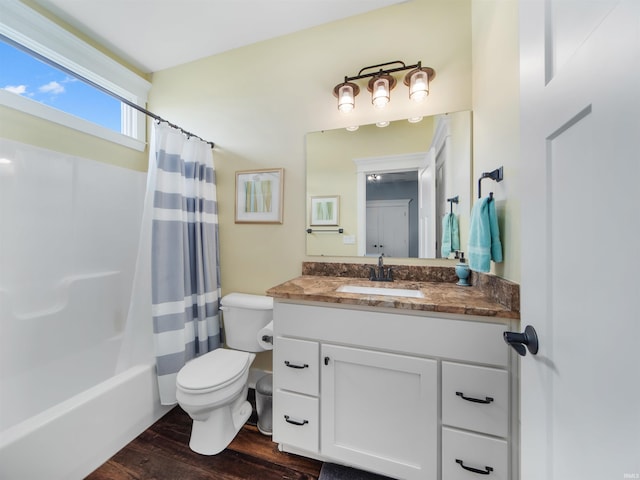 full bathroom featuring toilet, hardwood / wood-style floors, vanity, and shower / tub combo with curtain