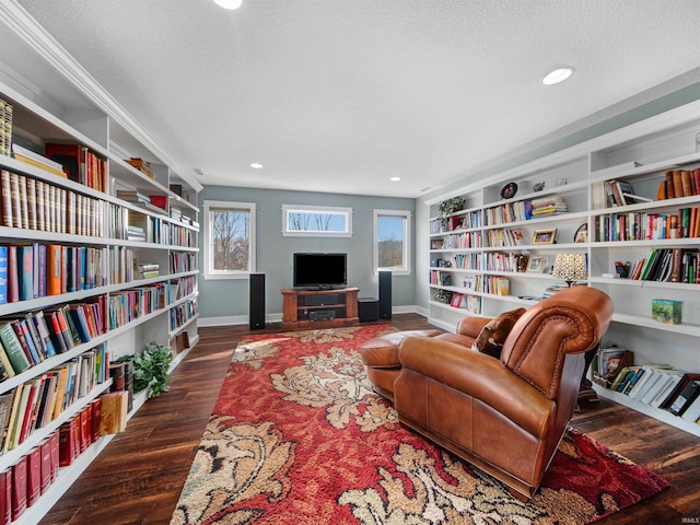 sitting room with built in features, dark hardwood / wood-style floors, and a textured ceiling