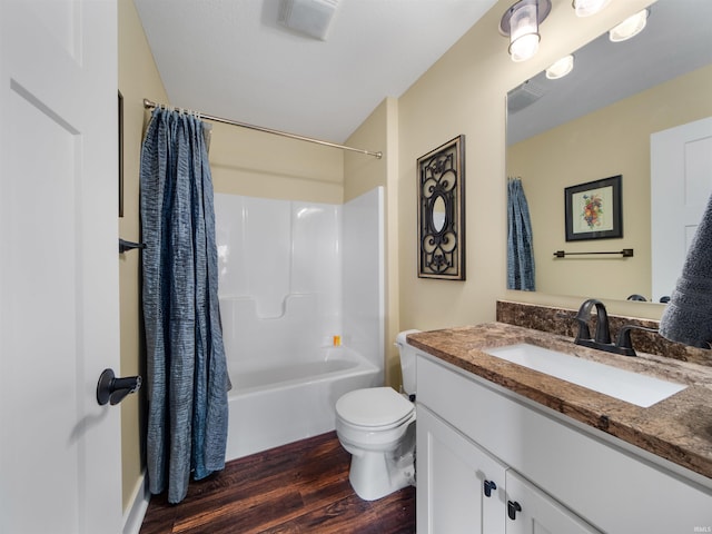 full bathroom with vanity, wood-type flooring, shower / tub combo, and toilet