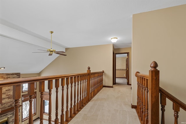 corridor featuring vaulted ceiling with beams and light colored carpet