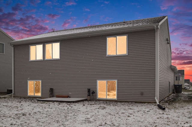 view of back house at dusk