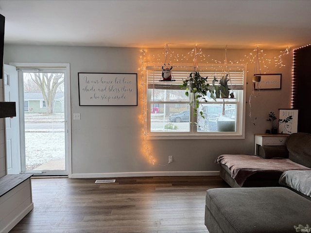 unfurnished living room with plenty of natural light and dark hardwood / wood-style floors