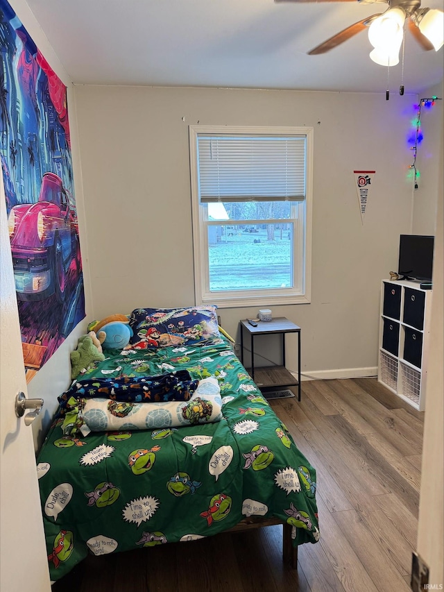 bedroom with wood-type flooring and ceiling fan