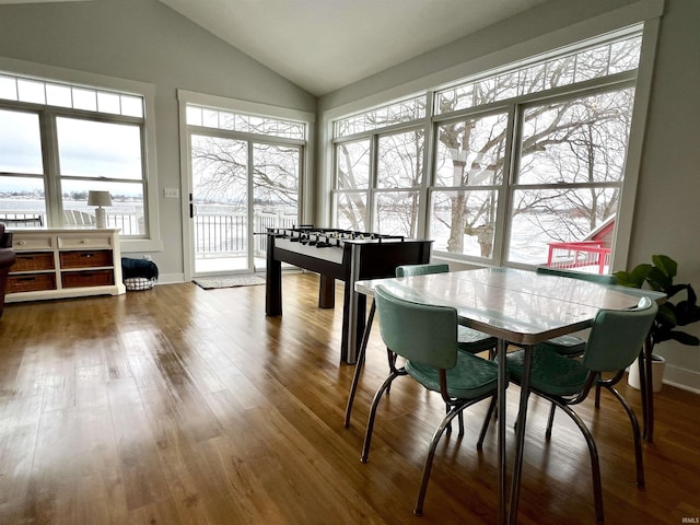 dining room featuring hardwood / wood-style floors and vaulted ceiling