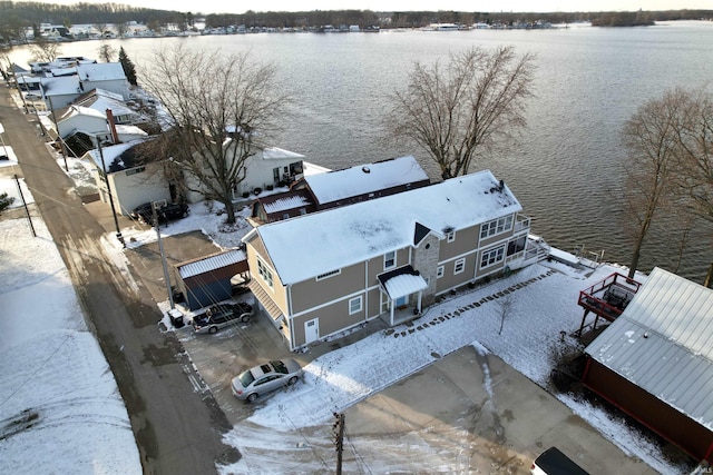 snowy aerial view featuring a water view