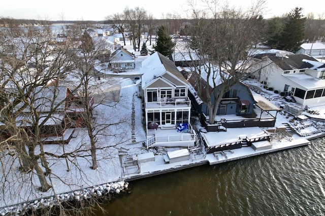 snowy aerial view with a water view