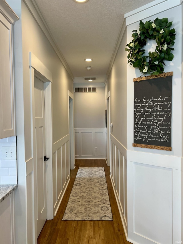 hall featuring dark hardwood / wood-style flooring and crown molding