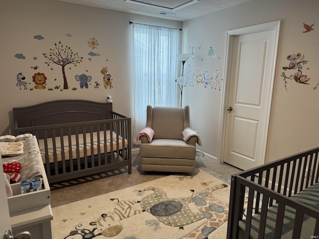 carpeted bedroom with a nursery area