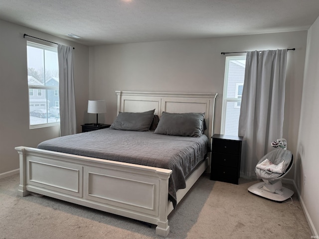 carpeted bedroom with multiple windows