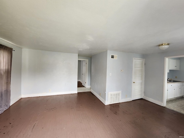 unfurnished living room featuring dark wood-type flooring