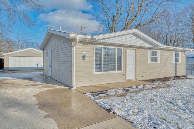 view of front of home with a garage and an outdoor structure