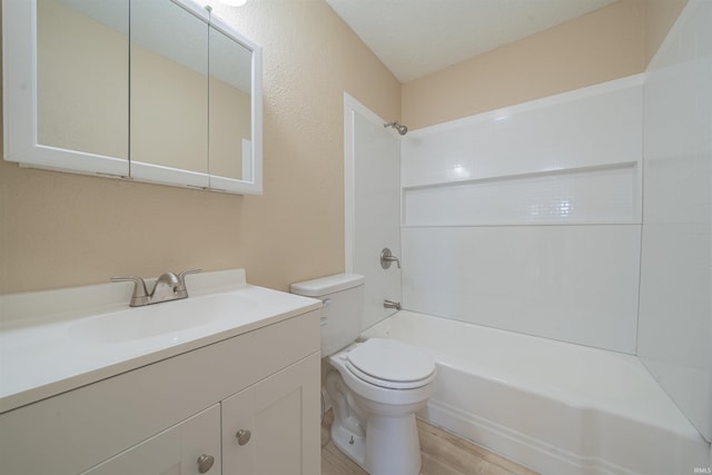 full bathroom with vanity, a textured ceiling, shower / bathing tub combination, wood-type flooring, and toilet