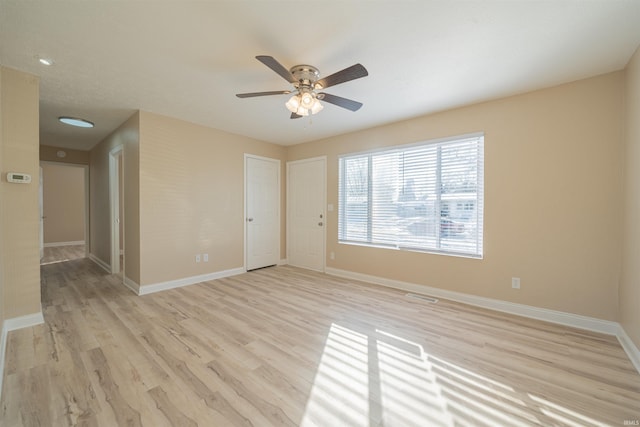 unfurnished room with light wood-type flooring and ceiling fan