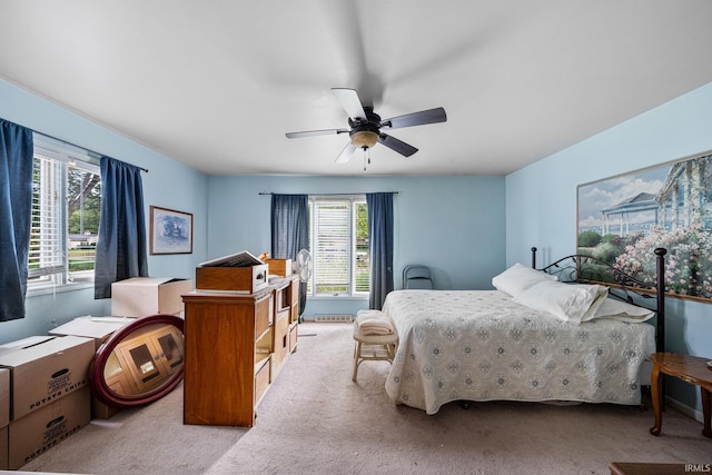 bedroom with ceiling fan and light carpet