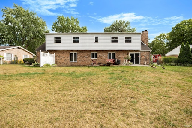 rear view of property with a yard