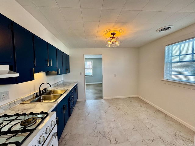 kitchen with ventilation hood, sink, white gas range, and blue cabinetry