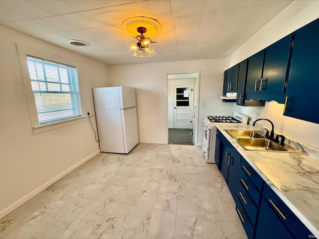 kitchen featuring blue cabinetry, white appliances, and sink