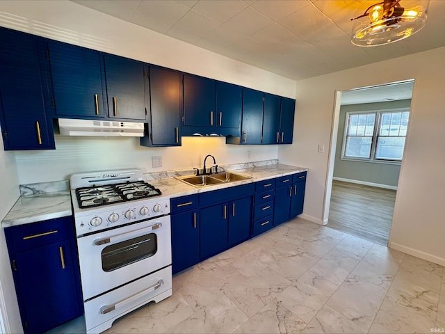 kitchen with blue cabinets, sink, and white range with gas cooktop