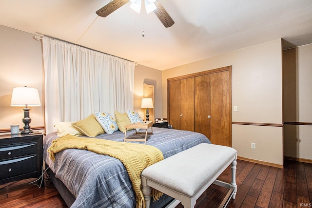 bedroom with a closet, dark hardwood / wood-style floors, and ceiling fan