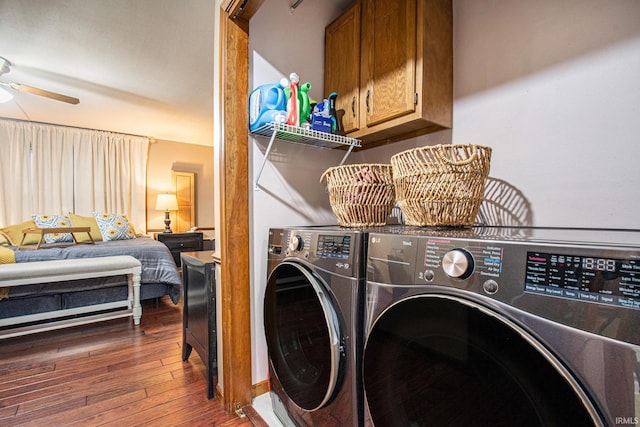 laundry room with ceiling fan, dark hardwood / wood-style flooring, and washing machine and clothes dryer