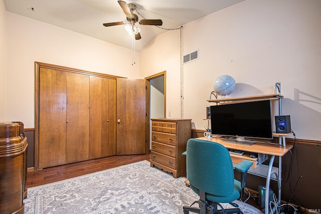 home office with light hardwood / wood-style flooring, ceiling fan, and lofted ceiling