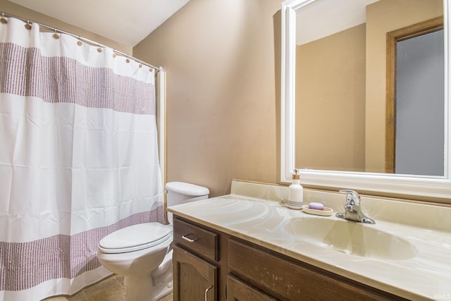 bathroom featuring tile patterned flooring, vanity, and toilet