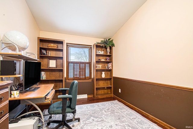 home office featuring light hardwood / wood-style flooring and lofted ceiling