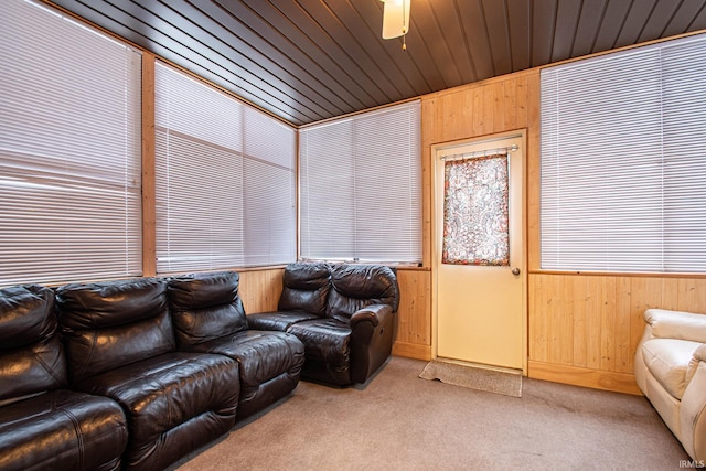 living room with light carpet, wooden ceiling, and wooden walls