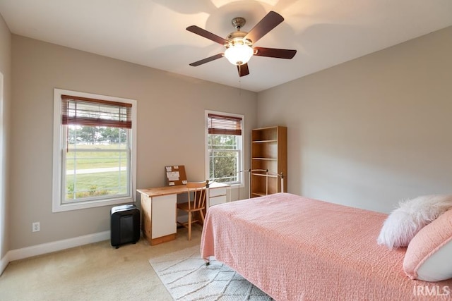 bedroom featuring light carpet and ceiling fan