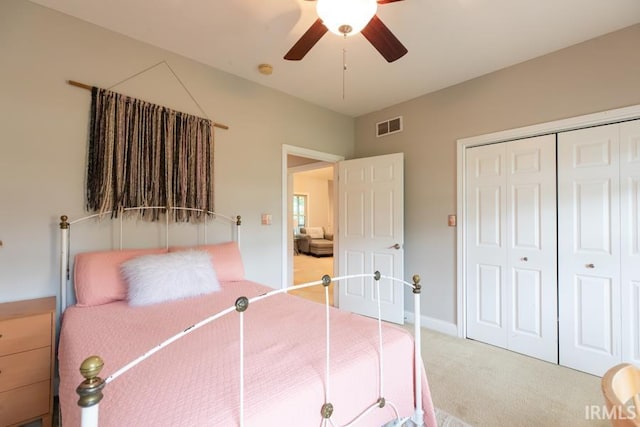 carpeted bedroom with ceiling fan and a closet