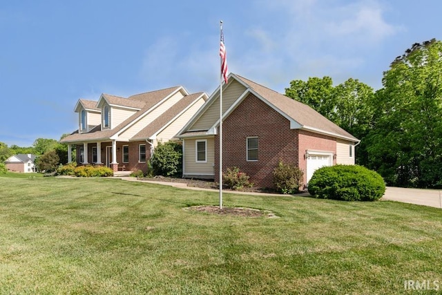 view of front of home with a front yard, a porch, and a garage