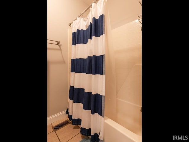 bathroom with tile patterned flooring and shower / bath combination with curtain