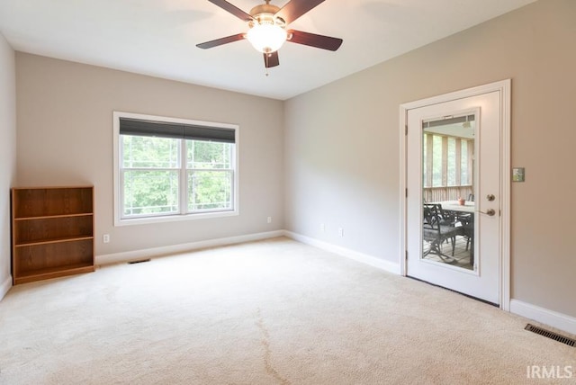 unfurnished room featuring light carpet and ceiling fan