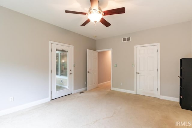 unfurnished bedroom featuring ceiling fan and light colored carpet