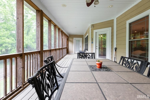 sunroom featuring ceiling fan