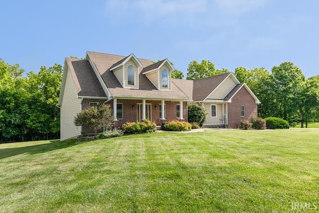 cape cod home featuring a front lawn