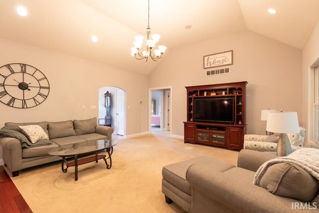 living room featuring vaulted ceiling and a notable chandelier