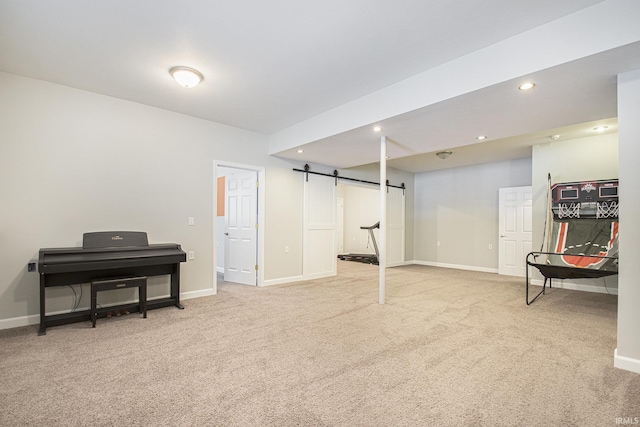 basement featuring a barn door and carpet floors