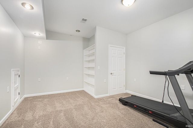 exercise room with light colored carpet