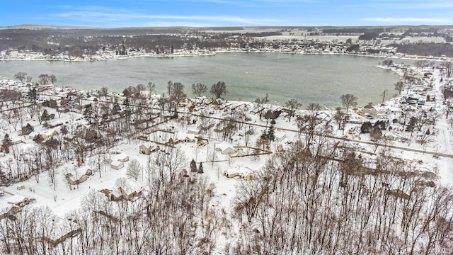 snowy aerial view with a water view