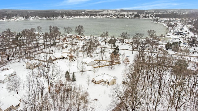 snowy aerial view featuring a water view