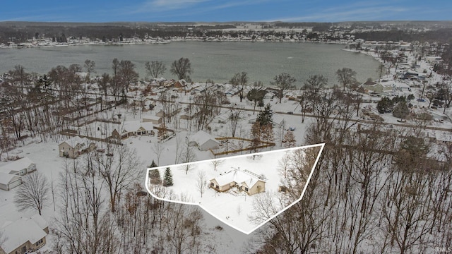 snowy aerial view featuring a water view