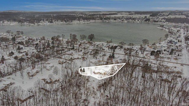 snowy aerial view with a water view