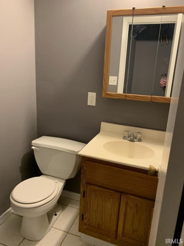 bathroom with tile patterned flooring, vanity, and toilet