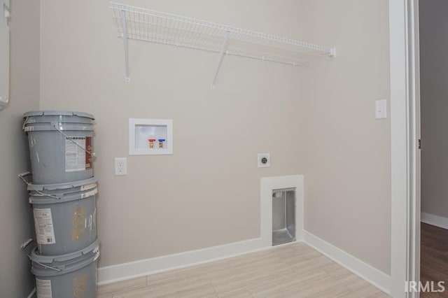 laundry area featuring washer hookup, hookup for an electric dryer, and light hardwood / wood-style flooring