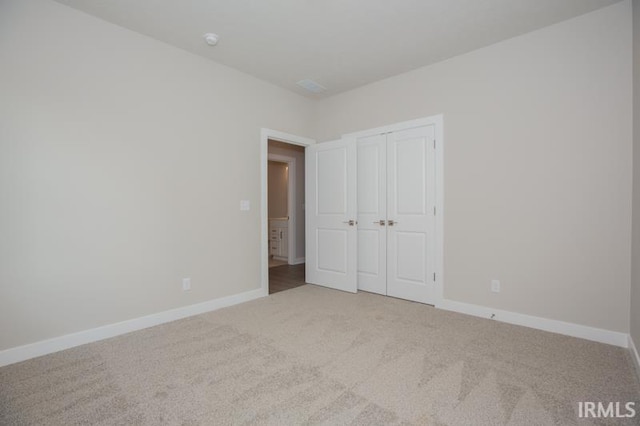 unfurnished bedroom with carpet floors and a closet