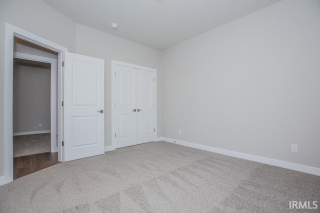 unfurnished bedroom featuring carpet flooring and a closet