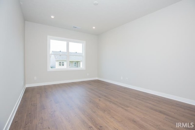 unfurnished room featuring hardwood / wood-style flooring