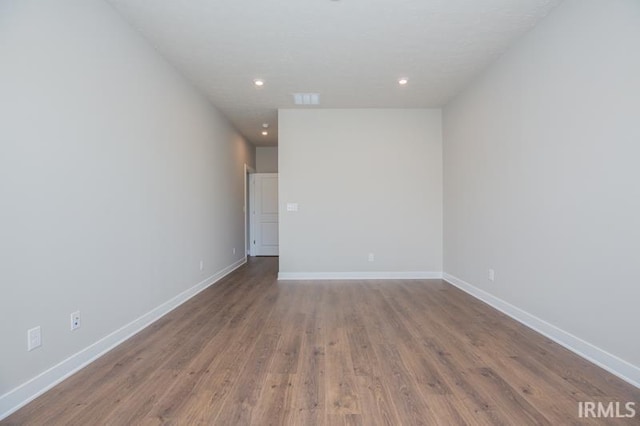 spare room with hardwood / wood-style flooring