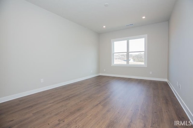 unfurnished room featuring dark hardwood / wood-style flooring